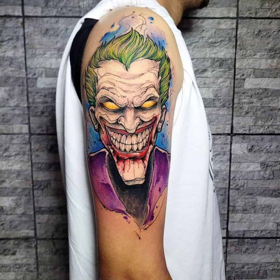 16. A comic book Joker tattoo on the upper arm