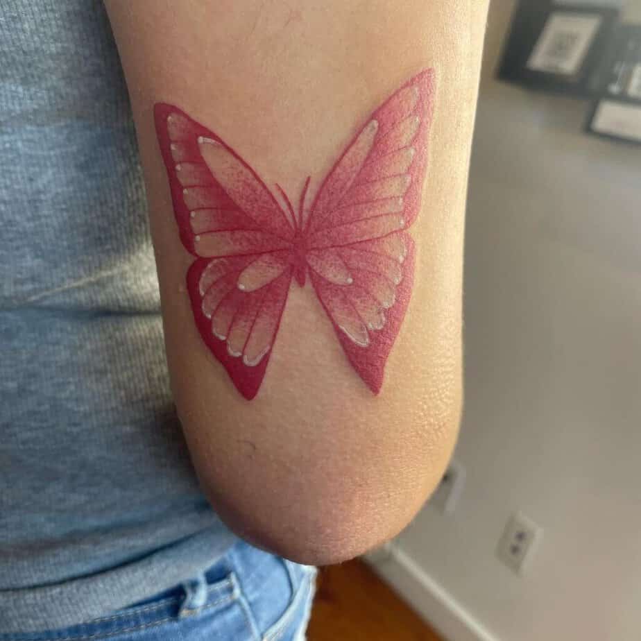 12. A red butterfly tattoo with white details