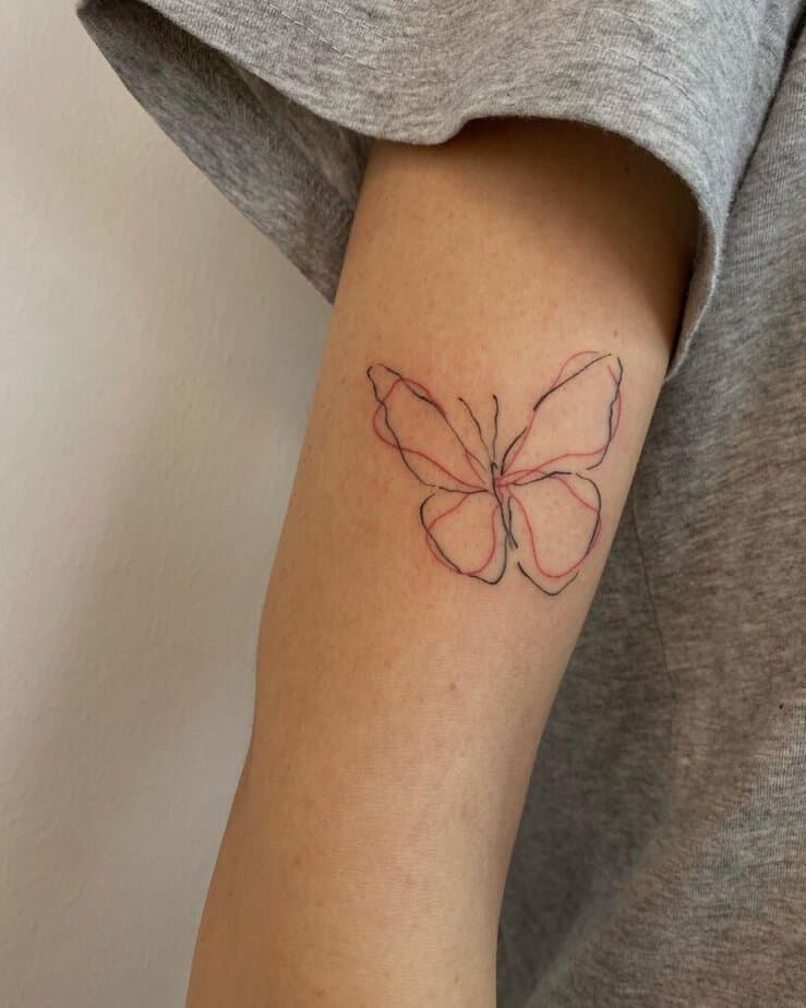 2. A red and black linework butterfly tattoo 