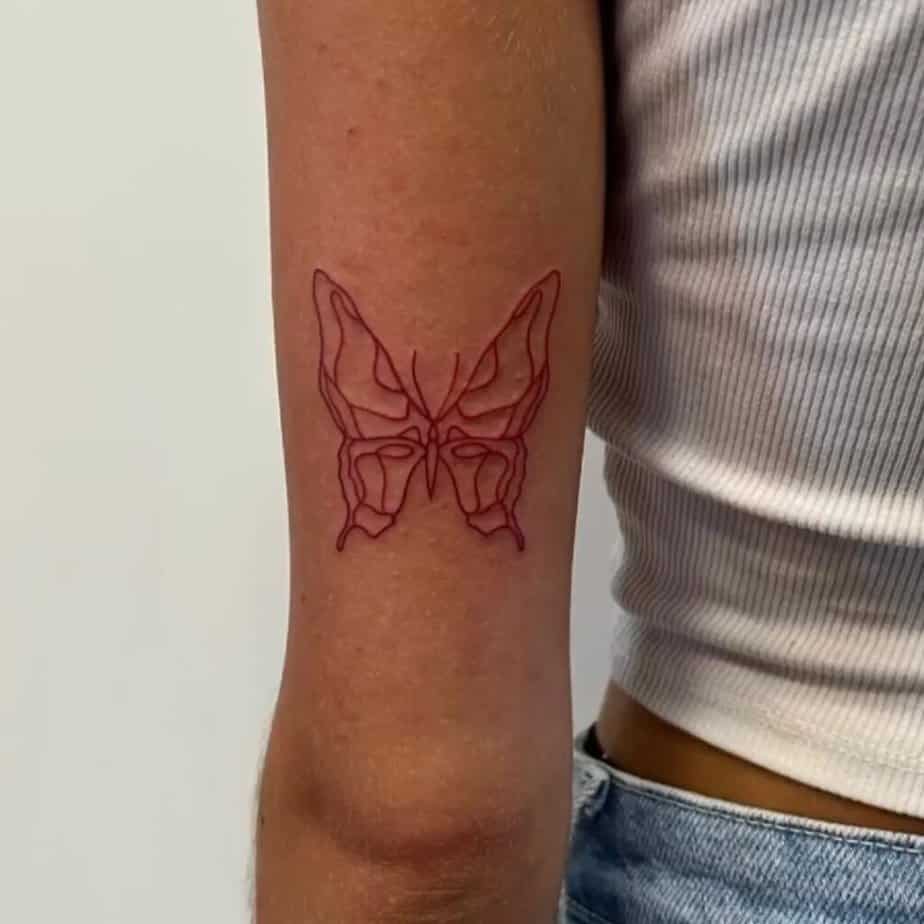 21. A linework red butterfly tattoo 