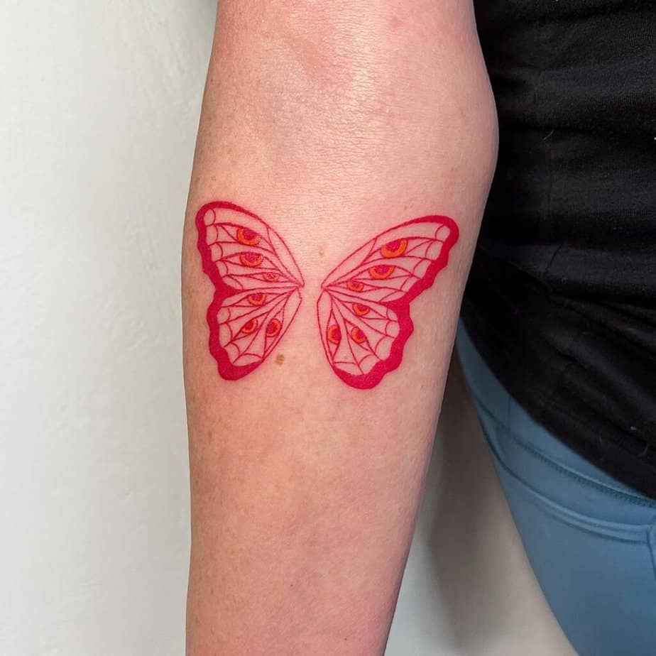 4. A flash tattoo of a red butterfly with eyes 