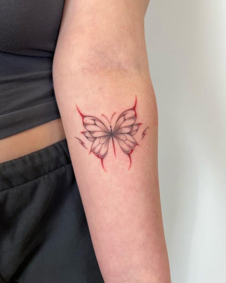 5. A red and black dotwork butterfly tattoo 