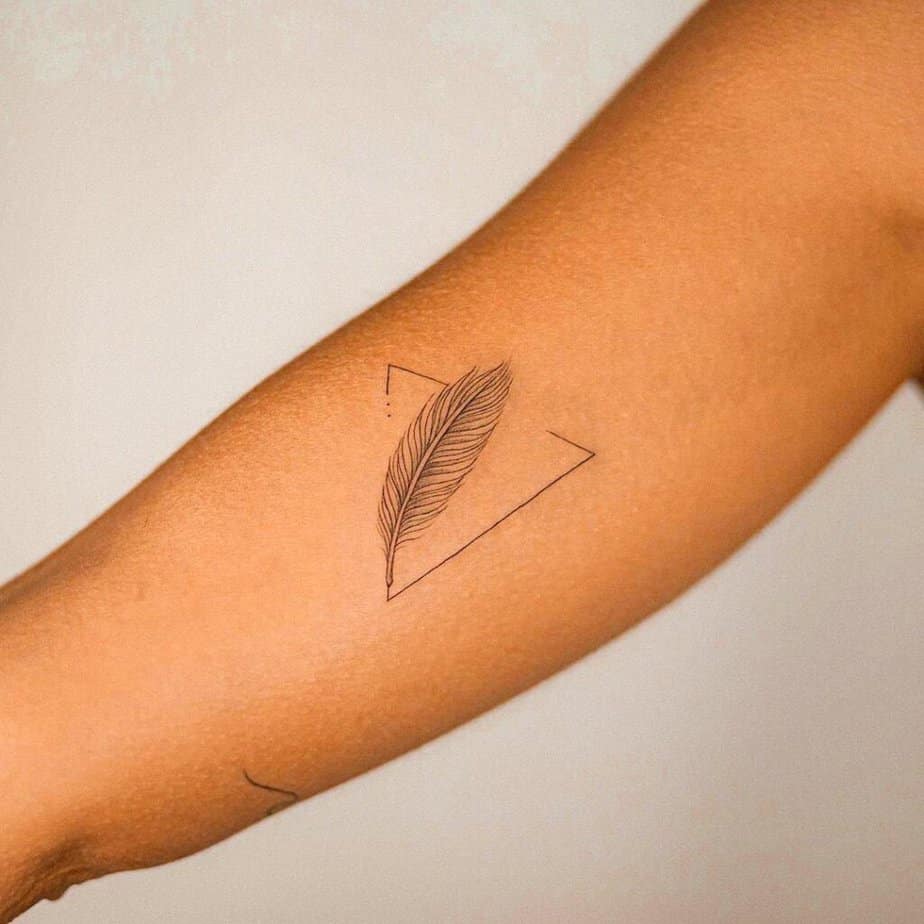 10. A feather tattoo with a modern twist 