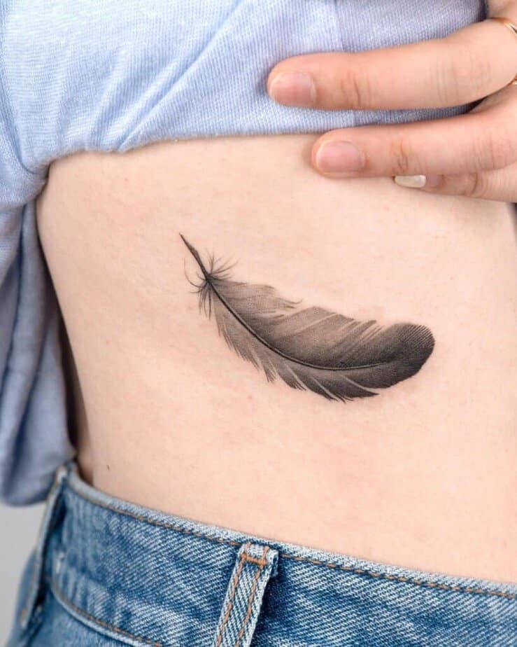 19. A feather tattoo on the side of the stomach 