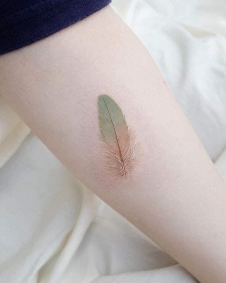 4. A green feather tattoo 