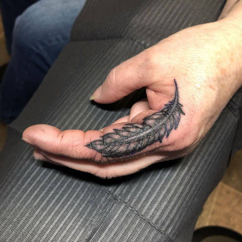 10. Straightforward feather tattoo
