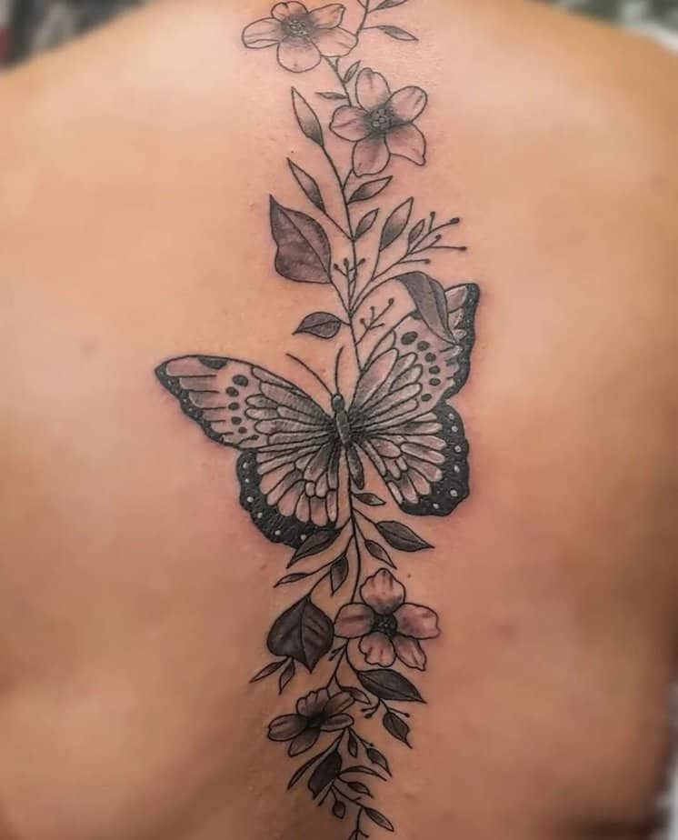 Vine back tattoo with butterflies