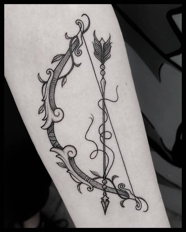 Big bow and arrow tattoo
