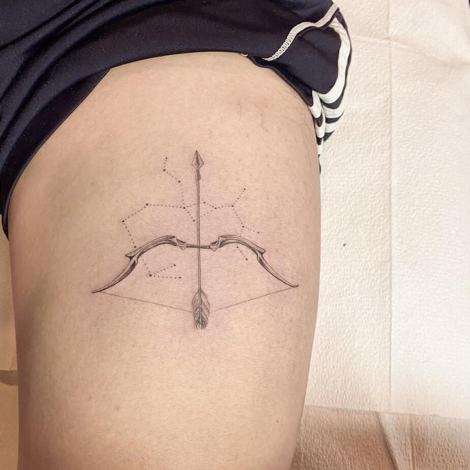 Elegant and simple bow and arrow tattoo
