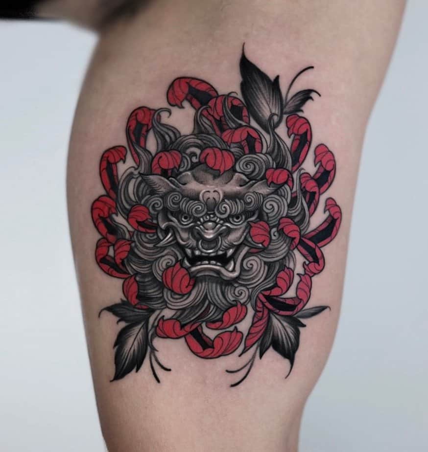 32. Hannya tattoo embraced in ribbons