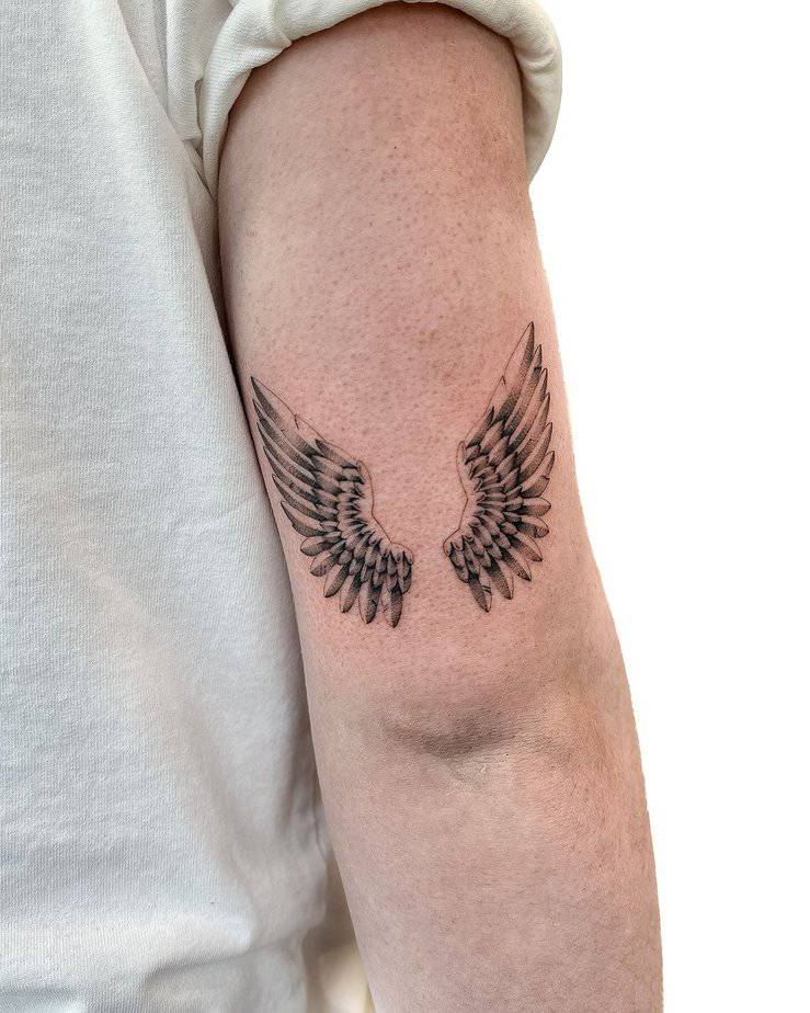 Beautiful wings arm tattoo