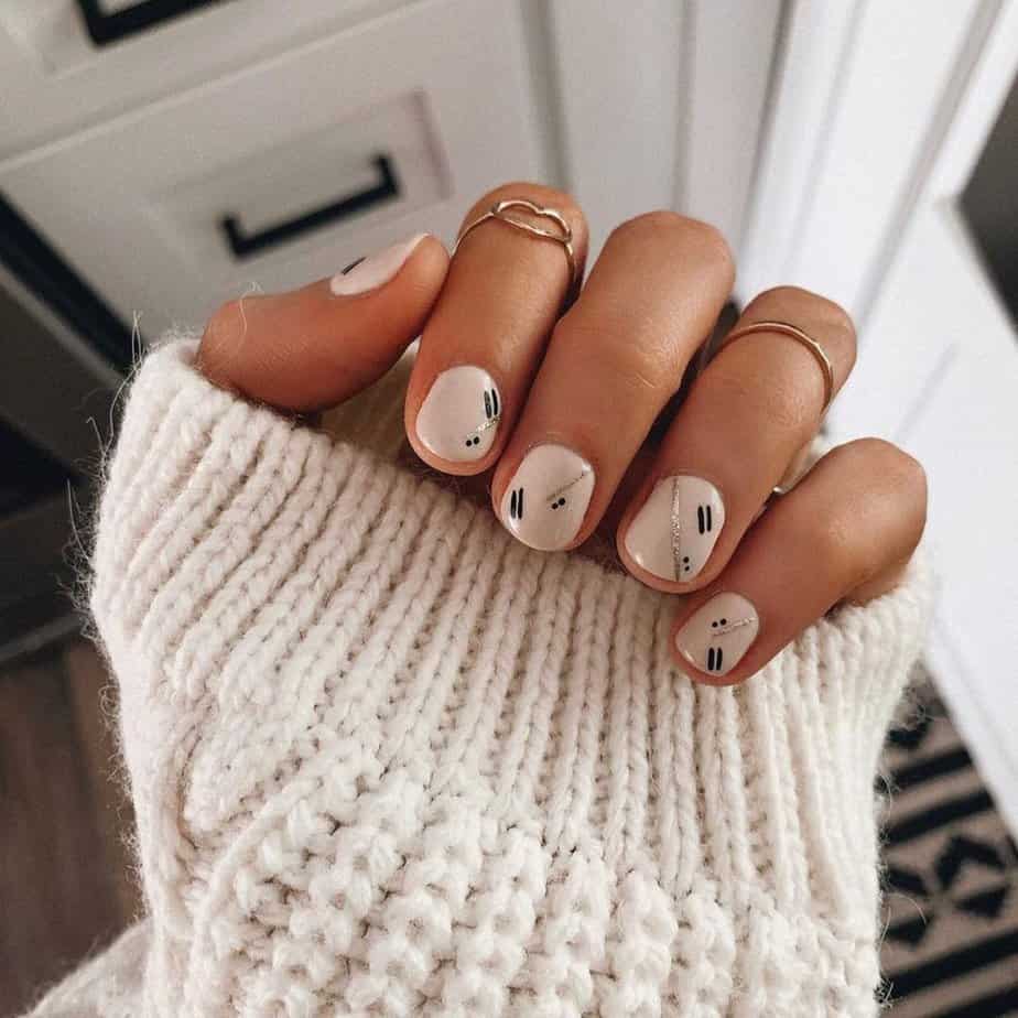 Neutral nails with gold and black details