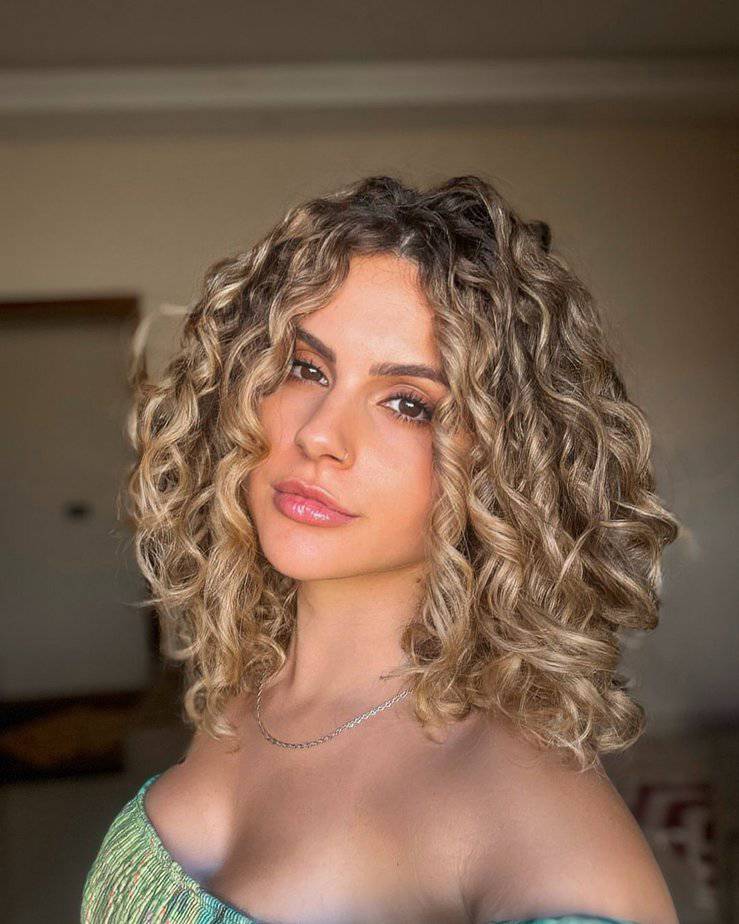 22. Sun kissed curls with golden highlights