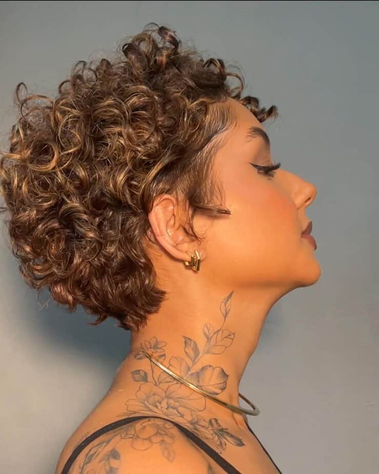 24. Curly pixie cut with golden highlights