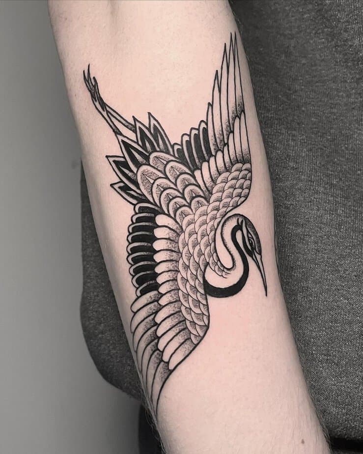 Black and gray crane tattoo