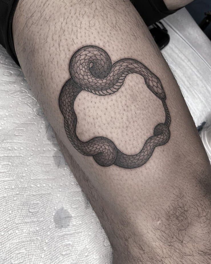 Bold ouroboros tattoo