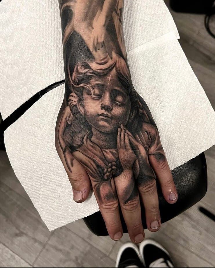 Hand cherub tattoo
