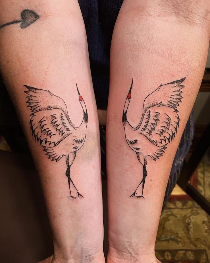 Matching crane tattoos