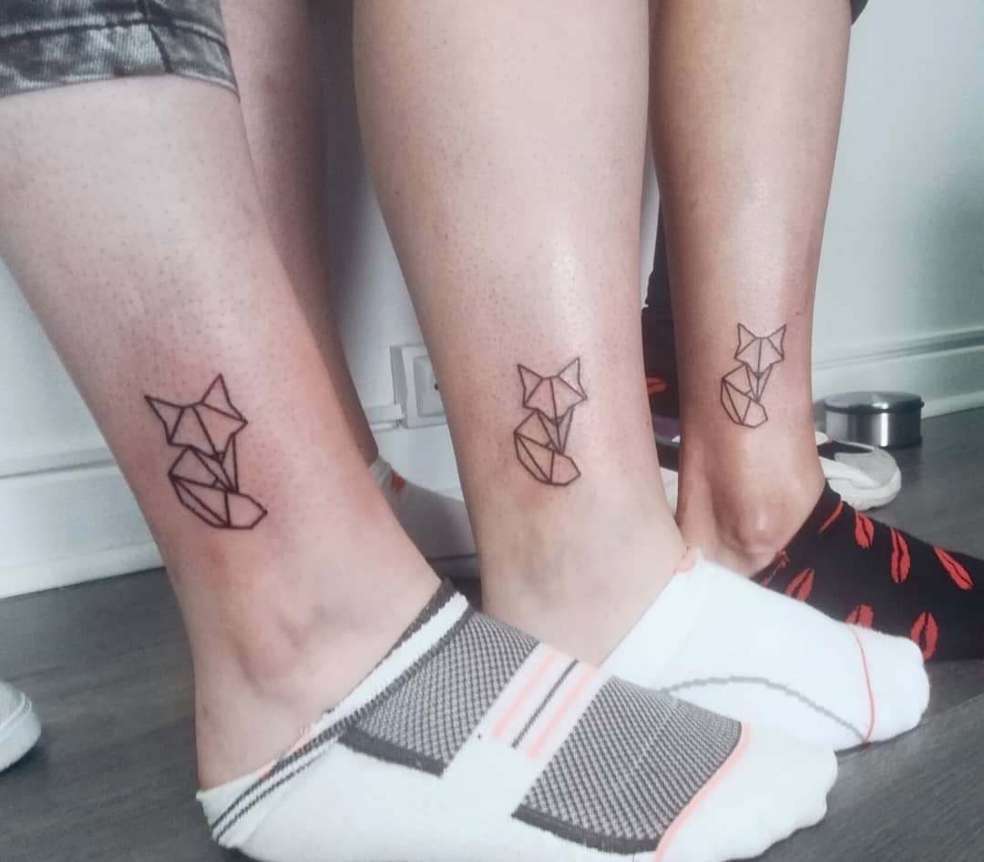 Matching geometric fox tattoos