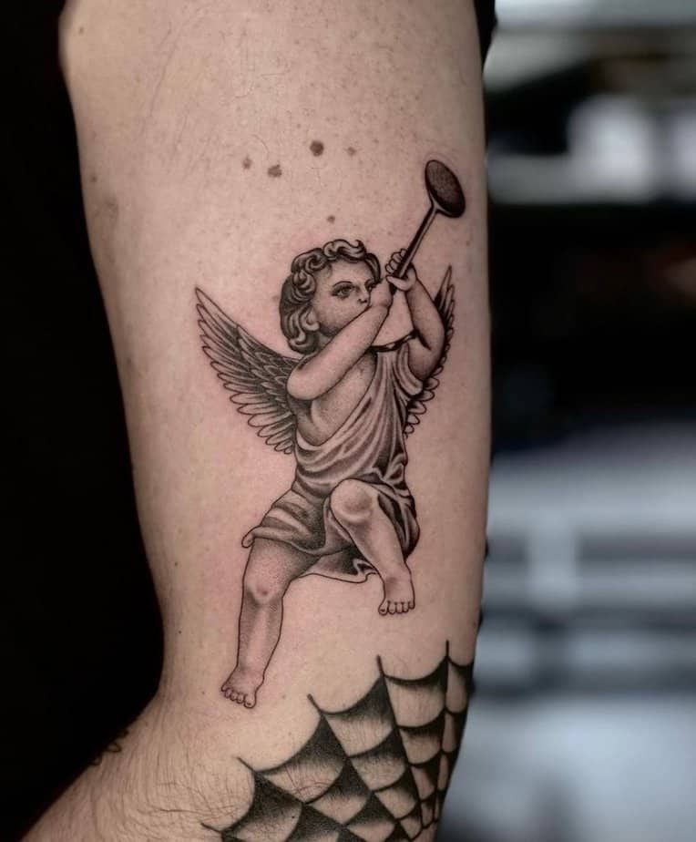 Musician cherub tattoo