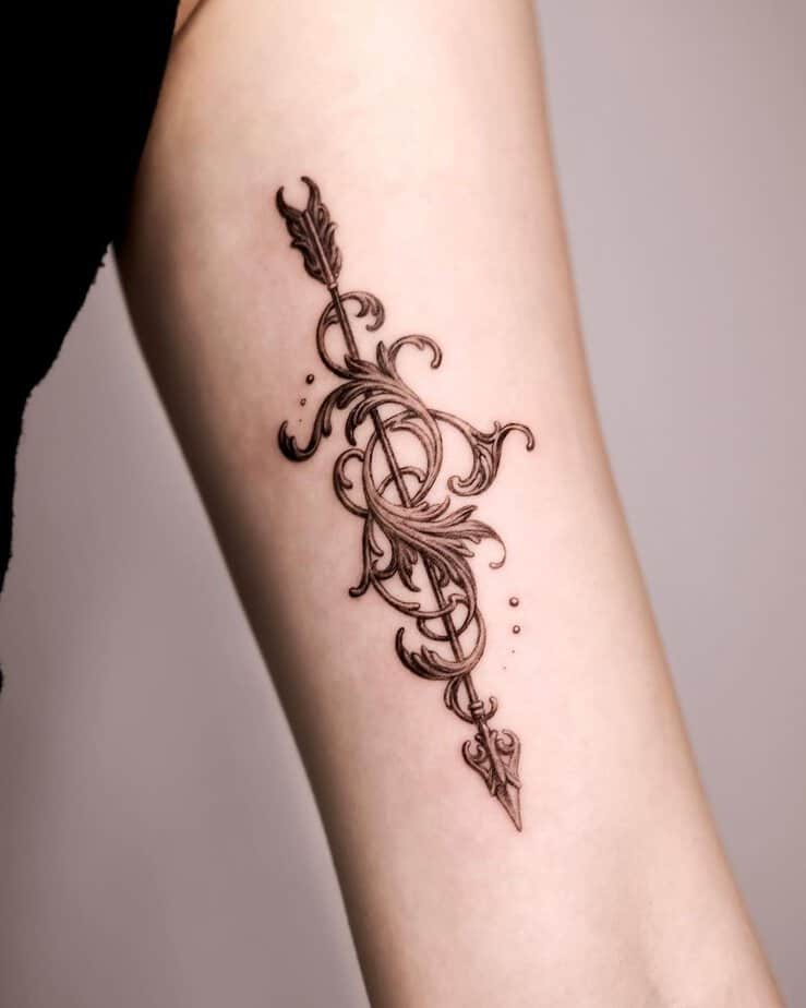 Ornamental arrow tattoo