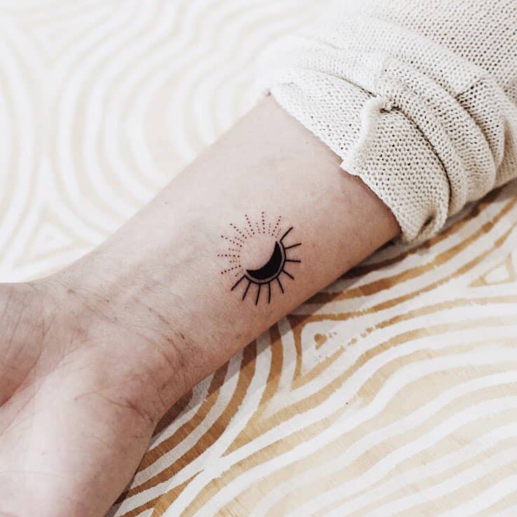 Sun and crescent moon tattoo