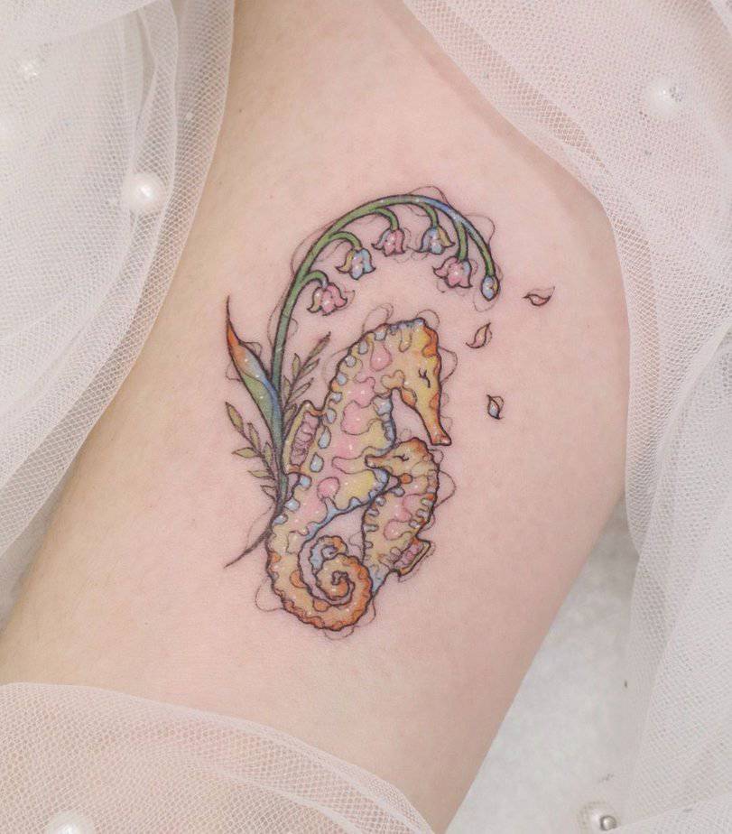 16. Pastel floral seahorse tattoo