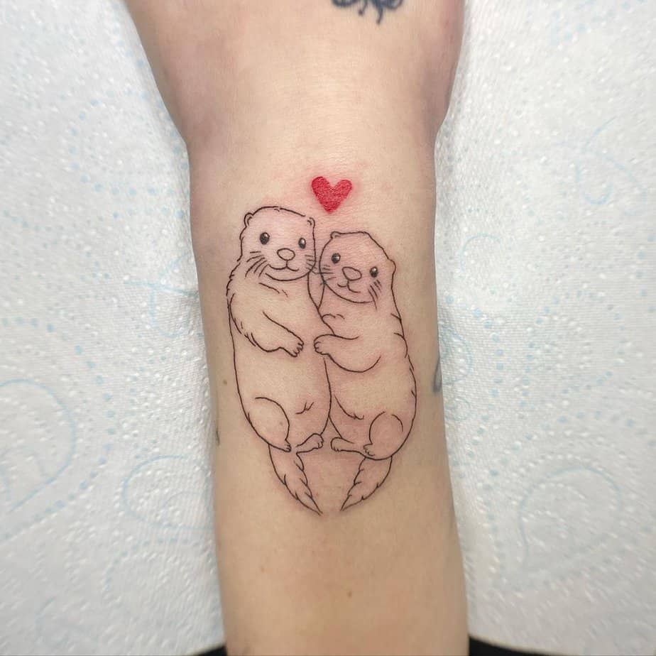 10. Otters in love with a heart