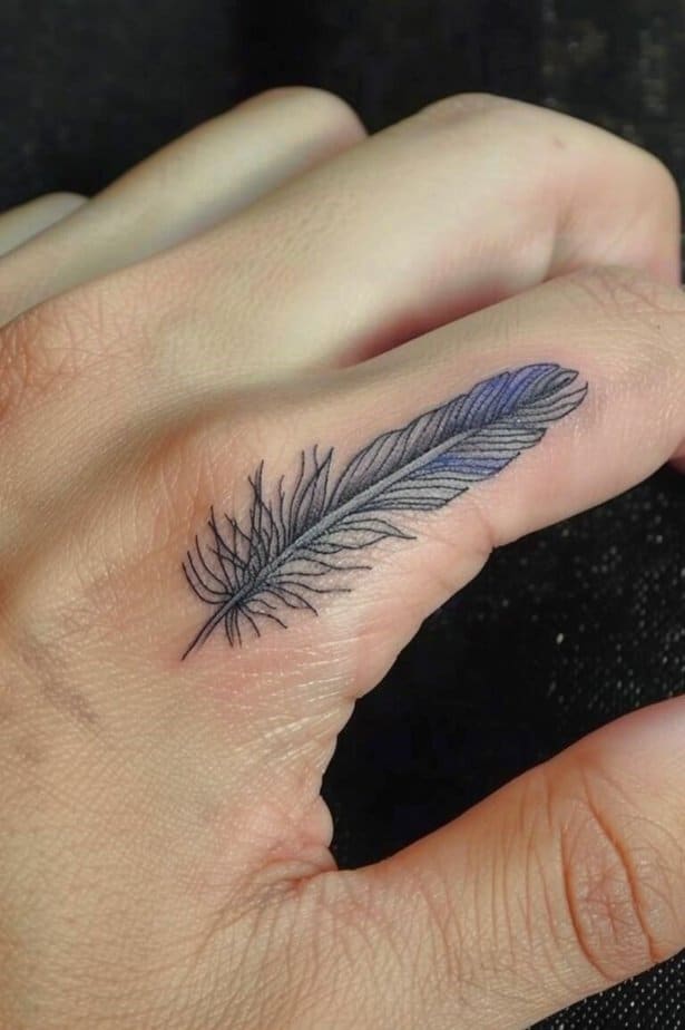 13. Feather tattoo with a touch of color