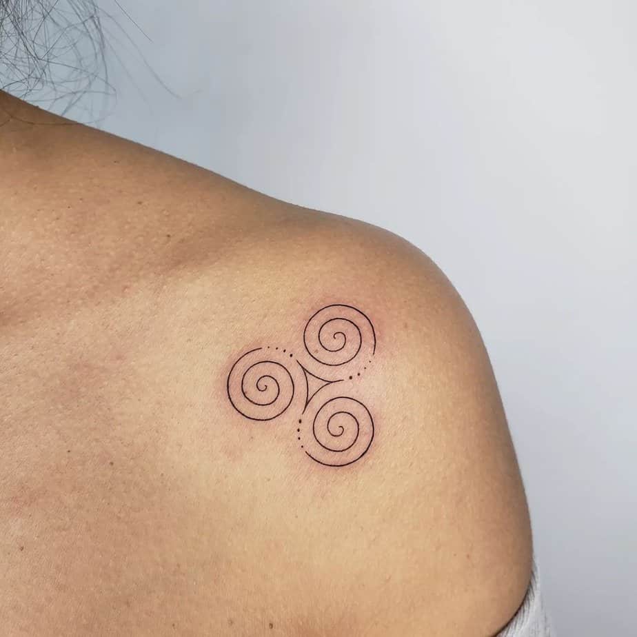 Fine line triskelion tattoo