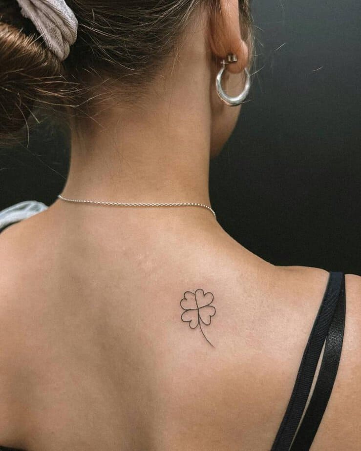 10. Back clover tattoo for timeless luck