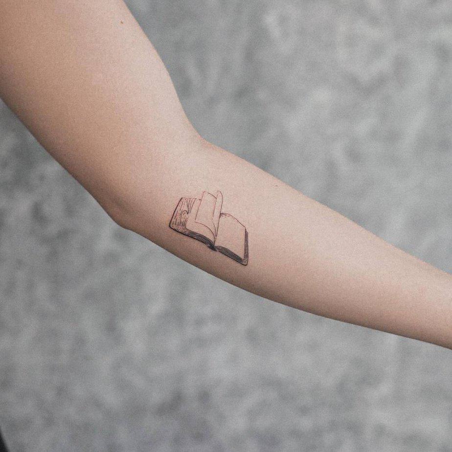 14. Minimalist open book tattoo