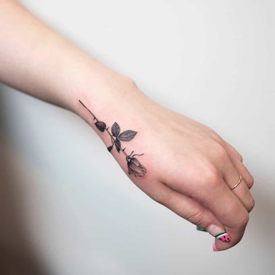 14. Thin black rose on the hand