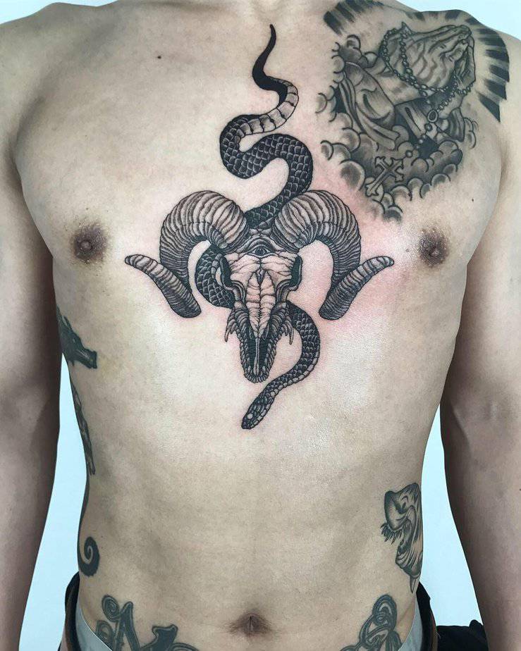 16. Black mamba and ram skull tattoo