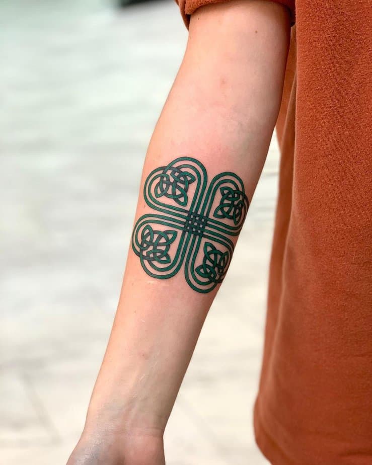 16. Green Celtic knot forearm tattoo