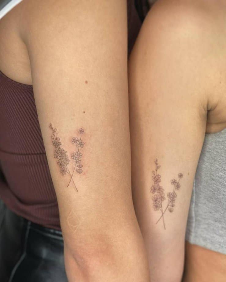 2. Matching minimalist larkspur tattoos