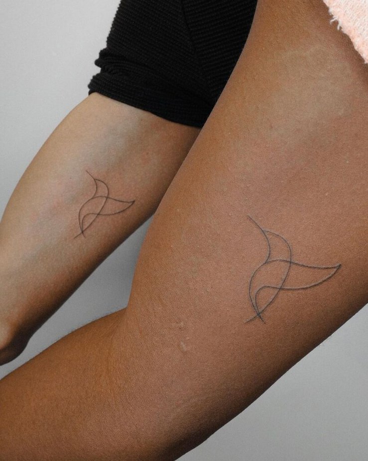 A matching abstract hummingbird tattoo 