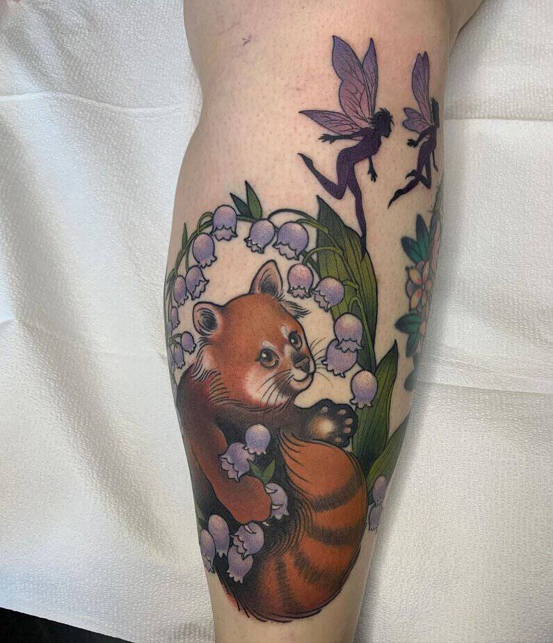 Red panda among lilies of the valley