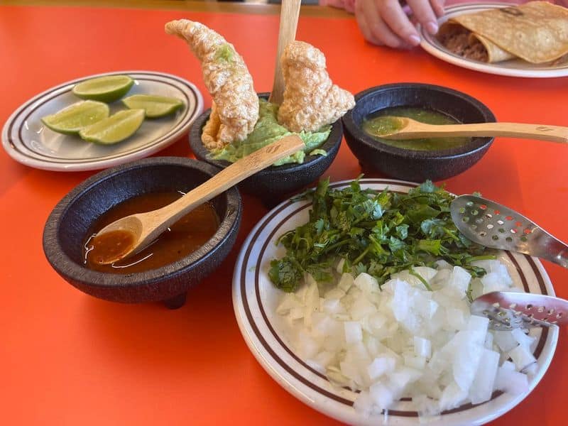 First Ever Los Cochinitos in the US Is Now Open in Texas — And It’s Nothing Like You Expect Guacamole Topped with Chicharrones