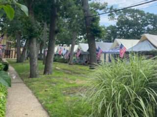 a historic new jersey village with over 100 tents lined up along the coast